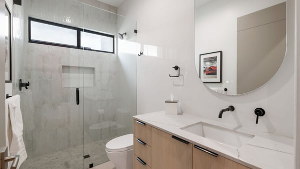 Updated bathroom with glass shower, modern vanity, and clean finishes. This Paradise Valley home features stylish upgrades throughout.