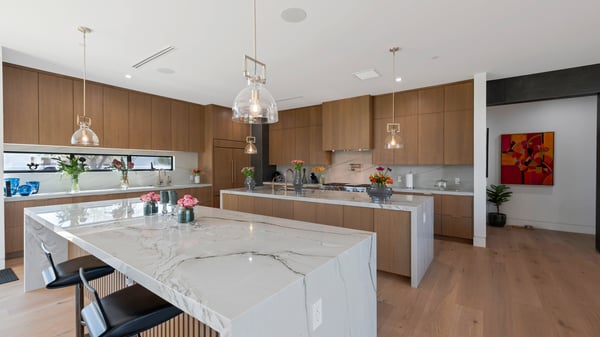 High-end kitchen with large island, quartz counters, and custom cabinetry. This Paradise Valley home is designed for entertaining and modern living.