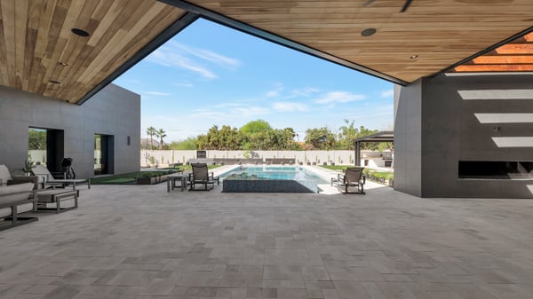 Open patio flowing into a sleek pool and landscaped yard. This Paradise Valley home offers a seamless connection between indoor and outdoor spaces.
