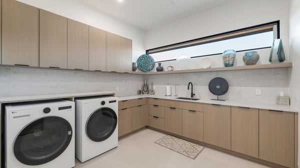 Stylish utility room with custom cabinetry, sleek countertops, and built-in sink. This Paradise Valley home offers a well-appointed laundry space with modern upgrades and efficient layout.