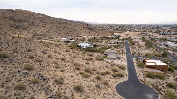 Wide panoramic aerial view capturing stunning desert landscapes, valley scenery, and hillside surroundings. This luxury Phoenix homesite offers privacy, views, and custom home potential in a scenic setting.