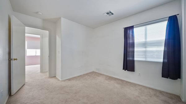 Spacious secondary bedroom offers neutral finishes, ample closet storage, and flexible living space suitable for guests, hobbies, or a quiet workspace.