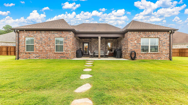 Spacious backyard with a well-maintained patio, perfect for outdoor gatherings and relaxation.
