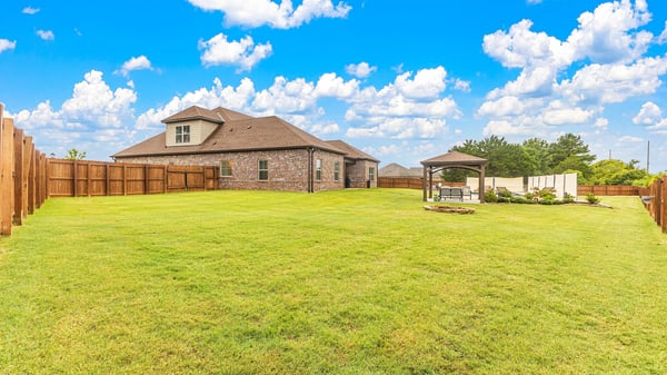 Spacious backyard with ample room for outdoor activities and a covered gazebo, perfect for gatherings.