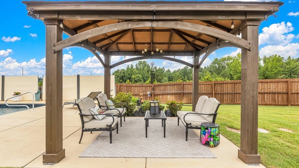 Discover this inviting outdoor space featuring a covered patio, perfect for relaxation and entertaining guests.