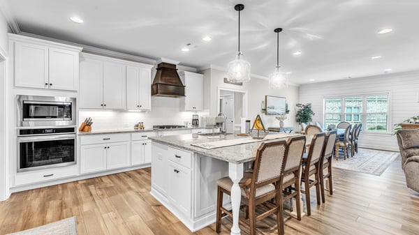 Bright and inviting kitchen featuring modern appliances, ample counter space, and a spacious dining area.