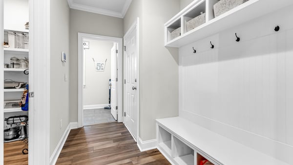 Bright and functional drop zone featuring built-in storage and hooks, perfect for organizing your space.