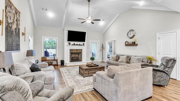 Spacious living room featuring a cozy fireplace, large windows, and ample seating for relaxation and entertainment.