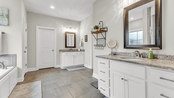 Spacious bathroom featuring dual sinks, ample counter space, and modern finishes, perfect for everyday convenience.
