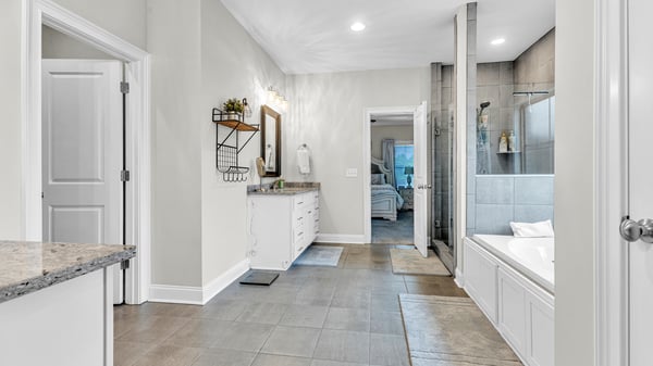 Spacious bathroom featuring a dual-sink vanity, modern shower, and bright, open layout for comfort.
