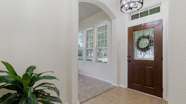 Entry way with updated lighting and gorgeous refinished front door.