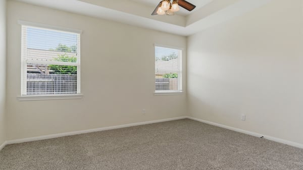 Fantastic primary bedroom with tray ceilings.