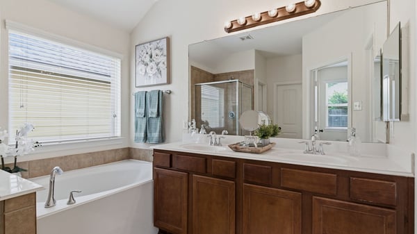 Primary bedroom boasts double sinks, a soaking tub, and separate shower. Plus TWO walk-in closets!
