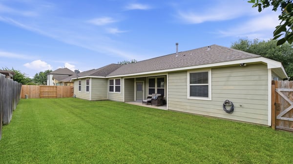Newer fence and well-maintained grass.