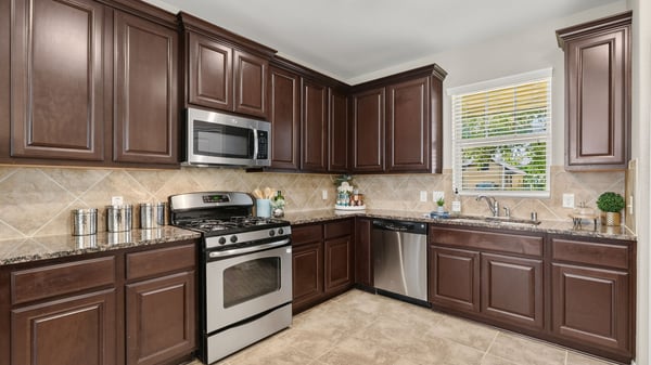 Modern kitchen featuring rich cabinetry, stainless steel appliances, and ample countertop space for cooking and entertaining.