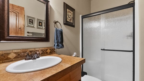 This well-designed bathroom features modern fixtures, ample storage, and a convenient layout for daily routines.
