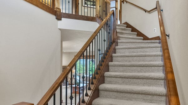 Ascend this beautifully crafted staircase leading to inviting living spaces filled with natural light.