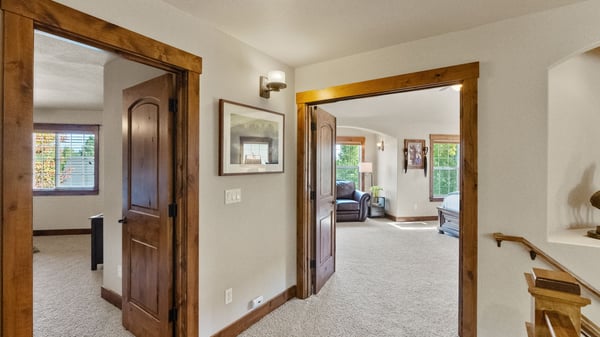 Spacious entryway leading to bright living areas, with abundant natural light and well-crafted wood accents.