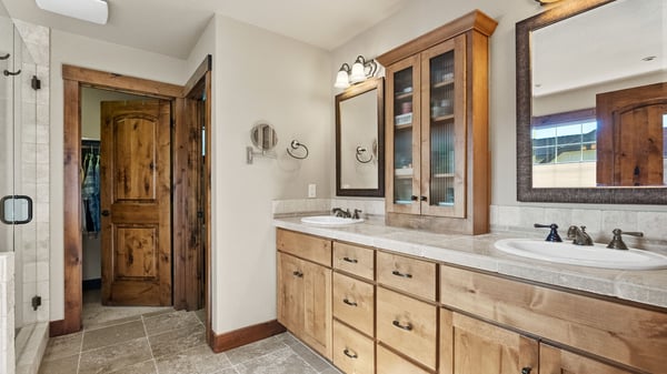 Spacious bathroom featuring ample storage, dual sinks, and natural light for a refreshing daily routine.