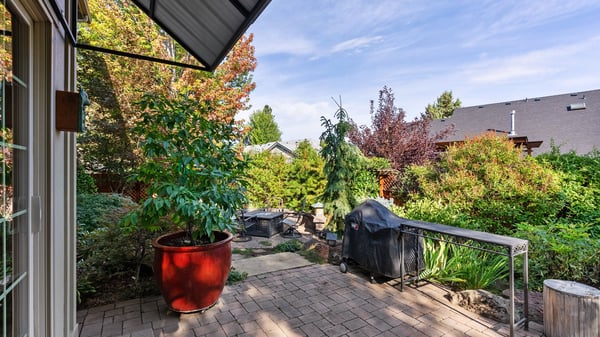 Spacious outdoor area with a patio, perfect for entertaining and enjoying lush garden views.