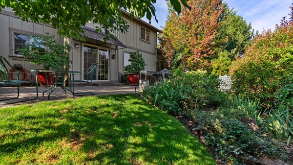 Discover a spacious backyard oasis featuring landscaped gardens and inviting patio areas for outdoor gatherings.