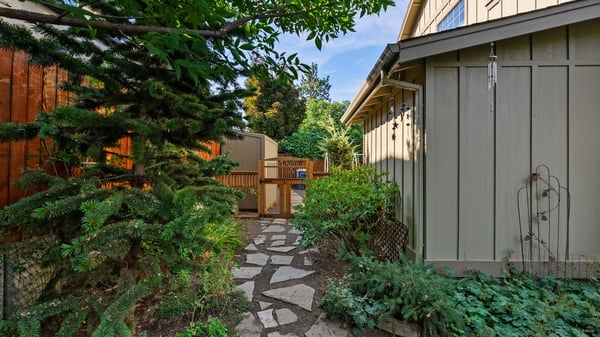 Discover a unique outdoor pathway leading to inviting spaces, surrounded by lush greenery and natural beauty.