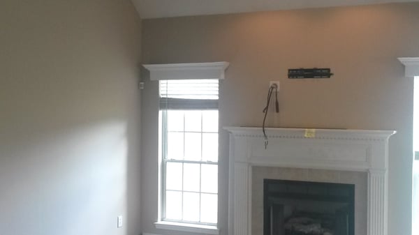 Bright living area featuring a fireplace and large windows, perfect for natural light and relaxation.