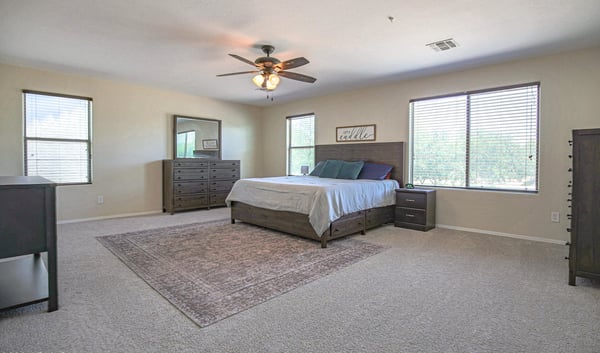 Large primary suite with abundant natural light, generous floor space, and room for additional seating or a private retreat. Designed for comfort and relaxation.