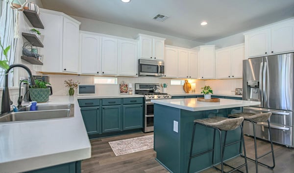 Bright, open kitchen with quartz countertops, stainless steel appliances, generous cabinet storage, and an oversized island perfect for meal prep, entertaining, and everyday living.
