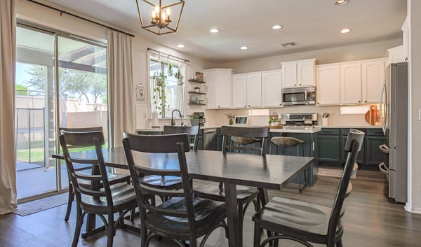 Spacious dining room with backyard views, large sliding glass doors, and an open connection to the updated kitchen, creating a bright and inviting entertaining space.