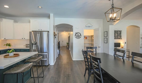 Expansive kitchen and dining area showcasing quartz countertops, oversized island seating, and a seamless flow that's ideal for hosting family and friends.