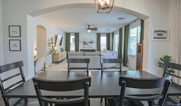 Spacious dining room overlooking the inviting family room through an elegant arched opening, creating a seamless layout that's perfect for entertaining and everyday gatherings.