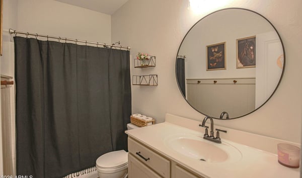 Clean and inviting hall bathroom with a spacious vanity, updated lighting, modern fixtures, and a convenient tub/shower combination serving the secondary bedrooms.