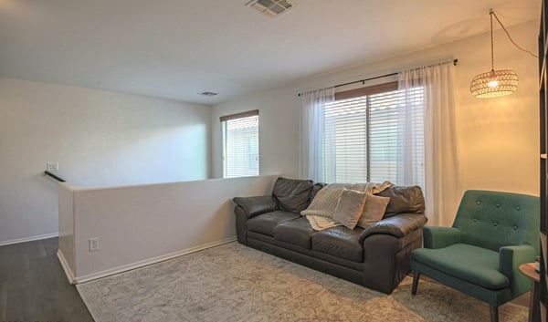 Open upstairs loft featuring updated flooring and flexible living space that's ideal for a home office, media room, homework station, or additional family lounge.