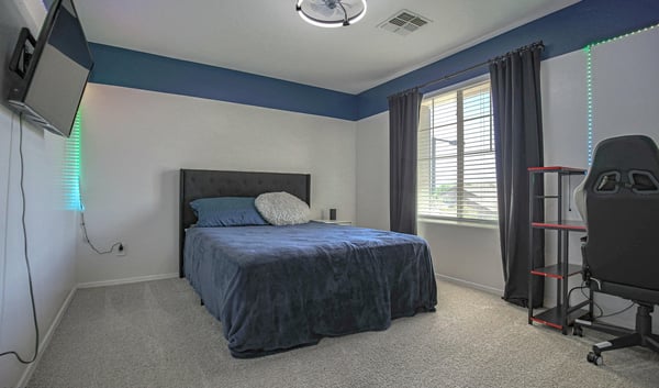 Inviting bedroom featuring plush carpeting, abundant natural light, and ample floor space for comfortable living. A flexible room suited for family, guests, or remote work.