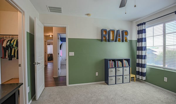 Well-appointed upstairs bathroom featuring an extended vanity, updated lighting, modern fixtures, and a convenient tub/shower combination. Designed to comfortably serve the secondary bedrooms in this beautiful Waddell home.