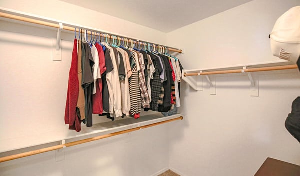 Spacious secondary walk-in closet featuring ample hanging space and flexible storage options, offering exceptional organization within the primary suite of this Waddell home.