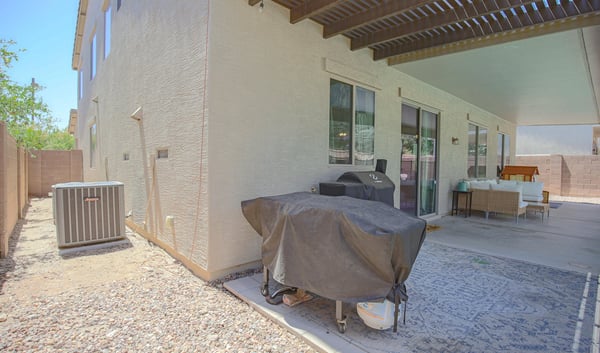 Covered patio with built-in grilling area, spacious seating, and convenient access to the backyard pool. A functional outdoor living area designed for entertaining in Waddell.