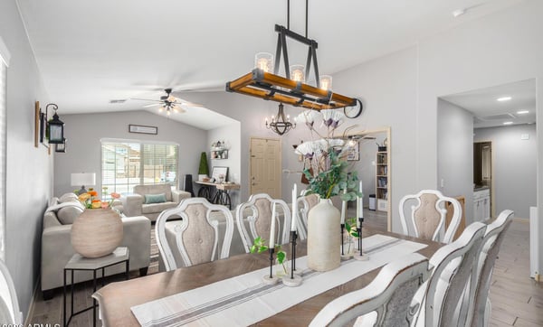The spacious dining area features designer lighting, updated flooring, and a seamless connection to the living room, creating the perfect setting for everyday meals and special occasions.