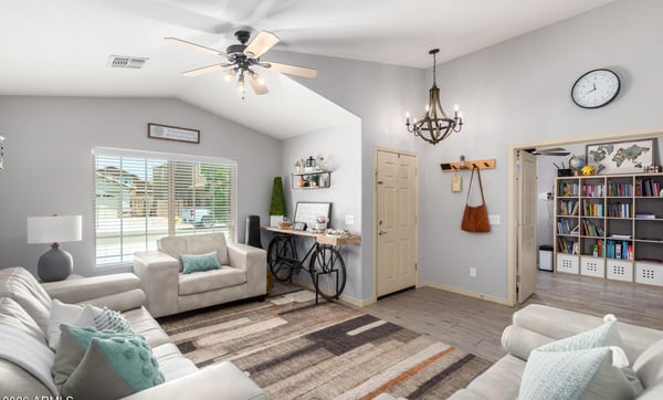 Filled with natural light and enhanced by vaulted ceilings, this spacious great room offers flexible living space that flows effortlessly into the dining area, making it perfect for entertaining.