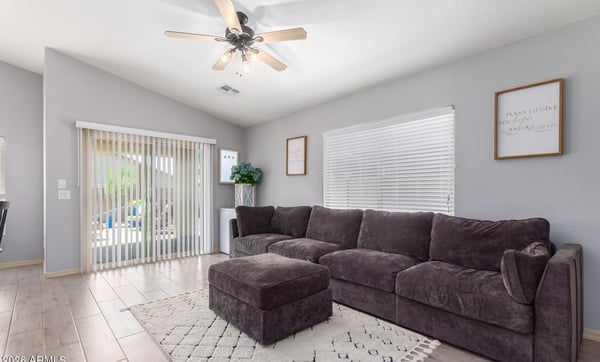 Relax in this inviting family room featuring large windows, ceiling fan, updated flooring, and direct access to the backyard patio. The open layout makes entertaining effortless while maximizing natural light.