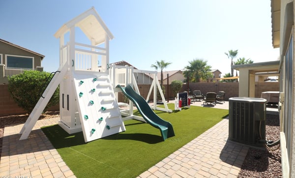 Families will appreciate the spacious backyard featuring a premium playset, artificial turf, paver walkways, and generous open space for recreation, entertaining, and everyday enjoyment.