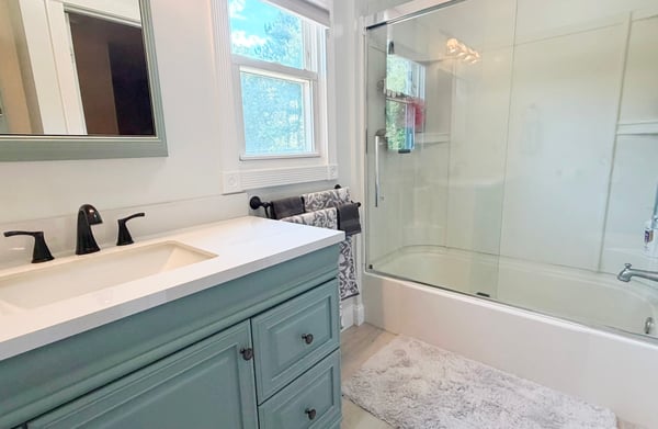 Full Bath w/ fiberglass tub/shower w/ updated glass sliding doors