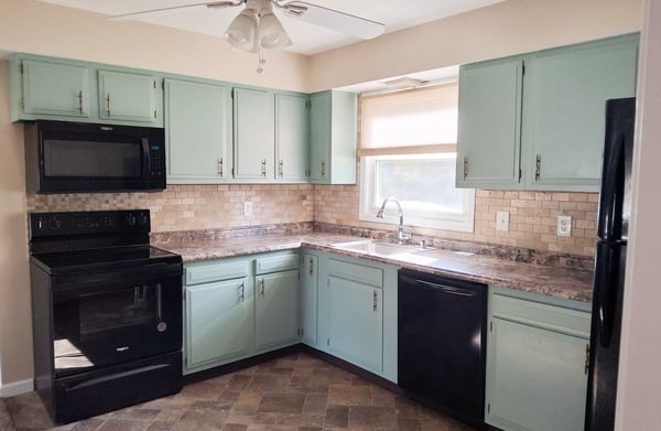 Apartment Kitchen when vacant but prior to cabinets painted & new counter Oct 2025 & prior to new range & microwave Dec 2025