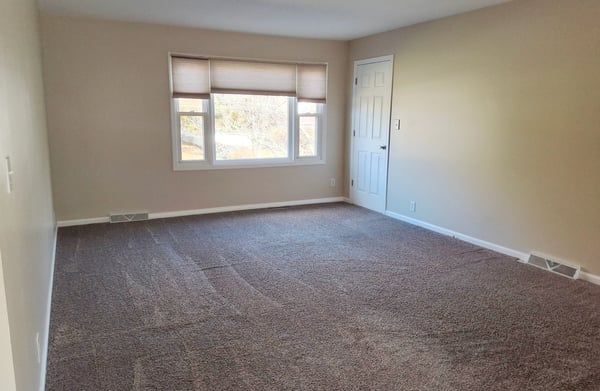 Apartment Living Room w/ storage closet, cordless shades & new carpet 2021 - empty view Fall 2025 before tenants