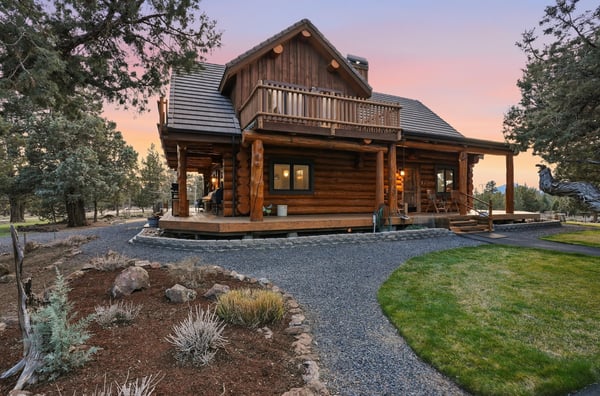 Discover this inviting log cabin retreat, surrounded by nature, featuring spacious outdoor areas and rustic appeal.