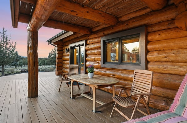 Discover a cozy log home retreat featuring a spacious deck, perfect for outdoor relaxation and gatherings.