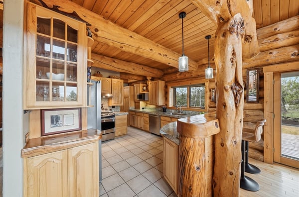 This spacious kitchen features natural wood accents, modern appliances, and ample light, perfect for culinary enthusiasts.