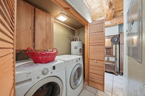 Convenient laundry area featuring modern appliances, smart storage solutions, and a practical layout.