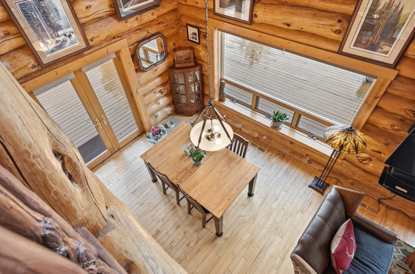 Experience rustic comfort in this cabin-style home featuring natural wood accents and spacious, open living areas.